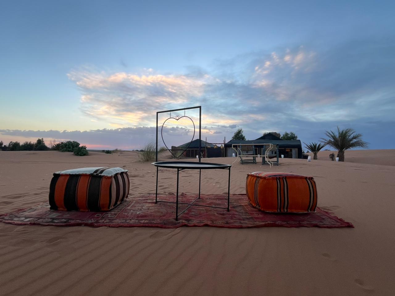 The sky glows in bands of orange and purple over the Erg Chebbi dunes at sunset, the transition to a night of stargazing under some of Earth's clearest skies.