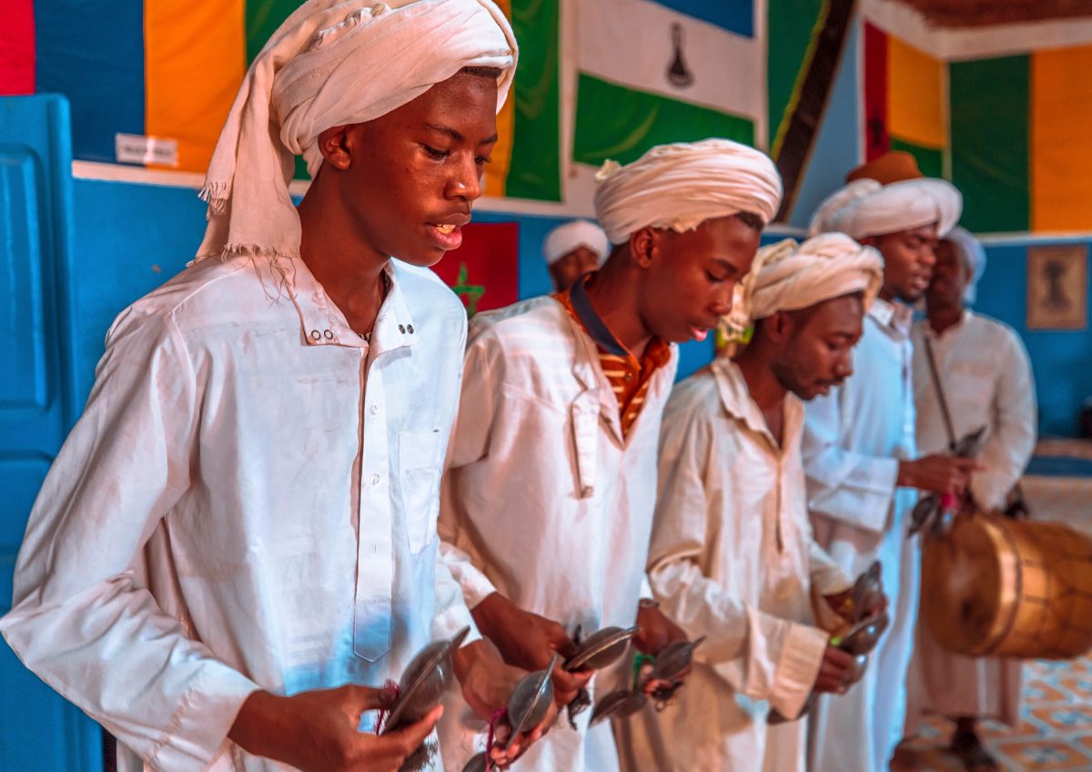 Merzouga stargazing experience tour under shooting stars across Morocco's Sahara Desert dunes.